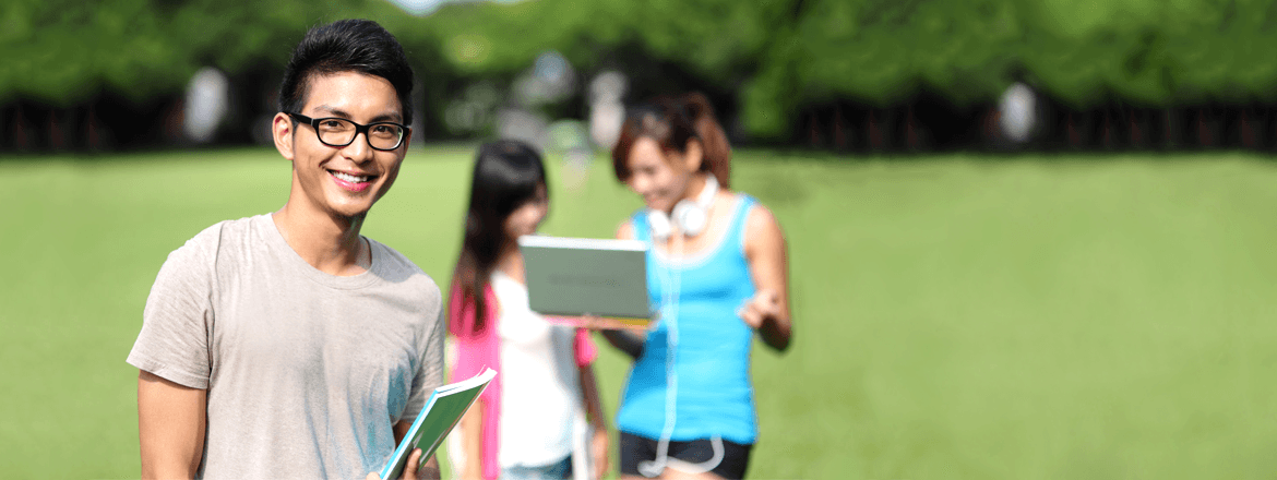 Student holding NCEA books on field
